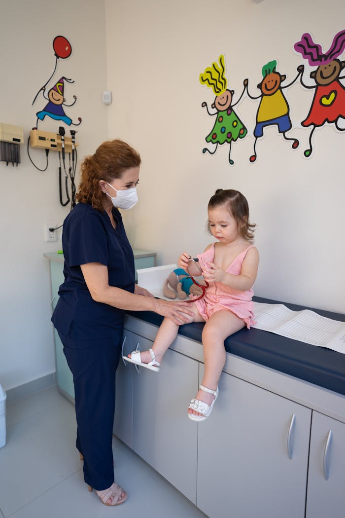A child is examined by a nurse in a pediatricians office, emphasizing gentle healthcare.